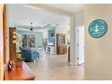 Open-concept living room with tile floors, sliding glass doors, comfortable seating, and ample natural light at 5333 Tide Point Way, Bradenton, FL 34208