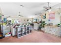 Bright living room with ceiling fans, modern decor, and a view into the open kitchen and dining area at 6178 Coliseum Blvd, Port Charlotte, FL 33981