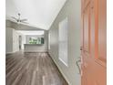 An inviting entryway featuring wood-look flooring, neutral paint, and natural light from the window at 6352 Robin Cv, Lakewood Ranch, FL 34202
