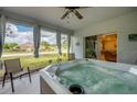 Relaxing sunroom featuring a luxurious hot tub, perfect for unwinding with a view of the outdoors at 640 Encarnacion St, Punta Gorda, FL 33983