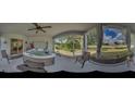 Panoramic view of the sunroom with hot tub, offering a serene escape and view of outdoor scenery at 640 Encarnacion St, Punta Gorda, FL 33983