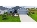 Charming single Gathering home featuring a two-car garage and a beautifully landscaped front yard at 6435 165Th E Dr, Parrish, FL 34219