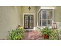 Charming front entrance with brick pathway, double doors and shuttered window at 7012 Treymore Ct, Sarasota, FL 34243