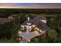Beautiful single-story home showcasing a tile roof, manicured landscaping, water view, and private setting at 7211 Pasadena Gln, Lakewood Ranch, FL 34202