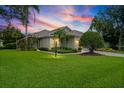 Charming single-story home featuring a well-manicured lawn, mature landscaping, and inviting curb appeal at 7424 Sea Island Ln, Bradenton, FL 34201