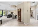 Open-concept living area featuring a tile entryway and an elegant grandfather clock near the living room with neutral decor at 7424 Sea Island Ln, Bradenton, FL 34201