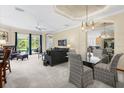 Spacious living room featuring a view of the screened-in pool, modern furniture, and neutral decor at 7424 Sea Island Ln, Bradenton, FL 34201
