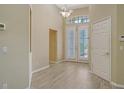 Bright foyer with wood floors, soaring ceilings, and French doors leading to living spaces at 7717 Us Open Loop, Lakewood Ranch, FL 34202