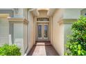 Elegant double front doors with brick entryway and adjacent manicured landscaping at 7717 Us Open Loop, Lakewood Ranch, FL 34202