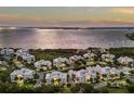 Aerial view of luxurious condos with waterfront views, lush landscaping, and resort-style amenities at 7840 34Th Ave W # 303, Bradenton, FL 34209