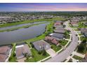 Beautiful aerial view of homes and community with lake, lush greenery, and blue skies at 7930 111Th Ter E, Parrish, FL 34219