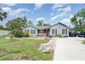 Lovely home featuring well-kept lawns, a stone-lined driveway, and mature trees at 9007 63Rd Avenue E Dr, Bradenton, FL 34202