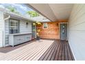 Charming porch area with wood accents, a built-in cabinet, and welcoming entrance at 9007 63Rd Avenue E Dr, Bradenton, FL 34202