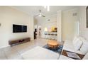 Bright living room boasts tile flooring, stylish bar stools, and an open layout leading into the kitchen at 1064 N Tamiami Trl # 1125, Sarasota, FL 34236