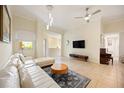 Cozy living room featuring tile floors, modern furnishings, and plenty of natural light from the window at 1064 N Tamiami Trl # 1125, Sarasota, FL 34236
