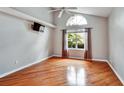 Bedroom with vaulted ceiling, hardwood floors, large window, and modern decor at 1112 Golfview Woods Dr # 1112, Sun City Center, FL 33573
