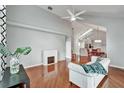 Bright living room with vaulted ceilings, fireplace, hardwood floors, and stylish furniture at 1112 Golfview Woods Dr # 1112, Sun City Center, FL 33573