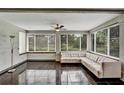 Bright sunroom with tiled floors, many windows with blinds, and comfortable seating at 1112 Golfview Woods Dr # 1112, Sun City Center, FL 33573