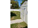 Spacious backyard featuring a well-kept shed with green grass and a white fence at 11707 104Th St, Largo, FL 33773