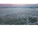 Inviting beach with gentle waves and a stunning sunset sky at 1240 Solitude Ln, Sarasota, FL 34242