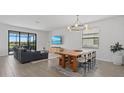 Open-concept living and dining area with modern furnishings and natural light at 15716 Barefoot Beach Dr, Bradenton, FL 34211