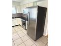 Well-equipped kitchen featuring stainless steel appliances, granite countertops, and bright white cabinetry at 1604 Chevy Chase Dr, Sun City Center, FL 33573