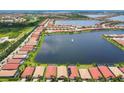 Scenic aerial view captures a residential community with a large lake and neatly arranged houses at 201 Vinadio Blvd, Nokomis, FL 34275