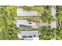 Bird's eye view of a home featuring solar panels, a driveway, and a well-manicured yard at 2218 Woodmere Rd, Venice, FL 34293