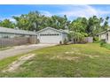 Charming single-story home featuring a two-car garage, well-maintained lawn, and mature landscaping at 2218 Woodmere Rd, Venice, FL 34293