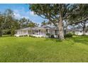 Sprawling single-story home featuring a large, well-maintained lawn and multiple windows at 2401 Riverview Blvd, Bradenton, FL 34205