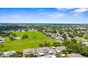 Panoramic aerial view showcases townhomes, pool, and community green space in lush neighborhood at 2915 29Th W Ave, Bradenton, FL 34205