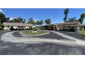Well-maintained community with carports and mature trees, providing a serene and comfortable living environment at 3032 Heron Lake Ct # 7B, Venice, FL 34293