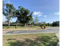 Community sign for Heron Lakes amidst lush landscaping and clear blue skies, showcasing a tranquil neighborhood at 3032 Heron Lake Ct # 7B, Venice, FL 34293