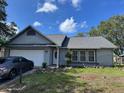 View of a cozy single-Gathering home with a green lawn and a driveway; car parked in front at 3404 56Th Dr E, Bradenton, FL 34203