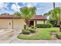 Villa exterior with a tile roof, two-car garage, and well-maintained landscaping at 3617 Yellow Pine Ct # 144, Sarasota, FL 34238