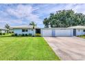 Charming single-story home with a well-manicured lawn, lush landscaping, and a two-car garage at 3721 Somerville Dr # 1513, Sarasota, FL 34232