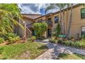 Exterior view features lush landscaping, wooden stairs, and a 'Paradise Ct' sign at 3810 75Th W St # 128, Bradenton, FL 34209