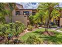 Charming exterior view of the condo with lush landscaping and walkway, showcasing curb appeal at 3810 75Th W St # 128, Bradenton, FL 34209