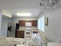 Modern kitchen with granite countertops, stainless steel appliances, and ample cabinet space at 4001 Beneva Rd # 319, Sarasota, FL 34233