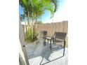 Cozy patio with seating, surrounded by lush landscaping and a privacy fence for tranquil relaxation at 4001 Beneva Rd # 319, Sarasota, FL 34233