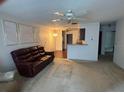 Spacious living room with a ceiling fan and adjacent breakfast bar provides easy flow to other areas at 4199 66Th Street W Cir # 4199, Bradenton, FL 34209