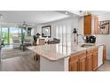 Open kitchen with granite countertops and stainless steel sink, seamlessly flowing into living area at 4440 Fairways Blvd # 310, Bradenton, FL 34209