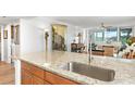 Spacious kitchen featuring granite countertops, stainless steel faucet, and open layout for entertaining at 4440 Fairways Blvd # 310, Bradenton, FL 34209