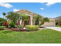 Charming single-story home with well-manicured lawn and mature tropical landscaping at 4531 Useppa Dr, Bradenton, FL 34203