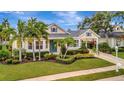 Charming home featuring lush landscaping, manicured lawn, and a covered carport at 4727 Starboard Dr, Bradenton, FL 34208