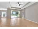Bright living room featuring neutral walls, recessed lighting, a ceiling fan, and tile flooring at 5005 Torrey Pines Run, Bradenton, FL 34211