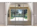 Covered screened-in patio with views of the large fenced-in backyard and peaceful water view at 5005 Torrey Pines Run, Bradenton, FL 34211
