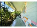 Spacious front porch featuring lush greenery and colorful brick accents at 5317 14Th S Ave, Gulfport, FL 33707