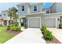 Two-story home showcasing an attached garage, lush lawn, and a welcoming entrance at 5711 Archipelago St, Nokomis, FL 34275
