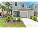 Charming two-story home with an attached garage and a well-kept lawn with shrubbery at 5711 Archipelago St, Nokomis, FL 34275